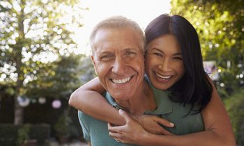 Image Text: A man and woman smiling and hugging in Arlington, TX