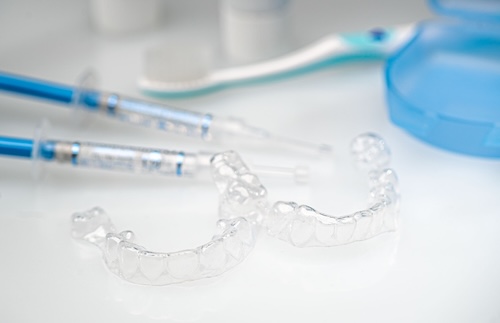 Teeth Whitening Splints, Gel Syringes and Accessories for Dental Care before and after Treatment. Image Text: teeth whitening maintenance
