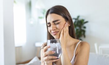 Image Text: woman with sensitive tooth, cracked tooth