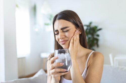 Image Text: woman with sensitive tooth, cracked tooth
